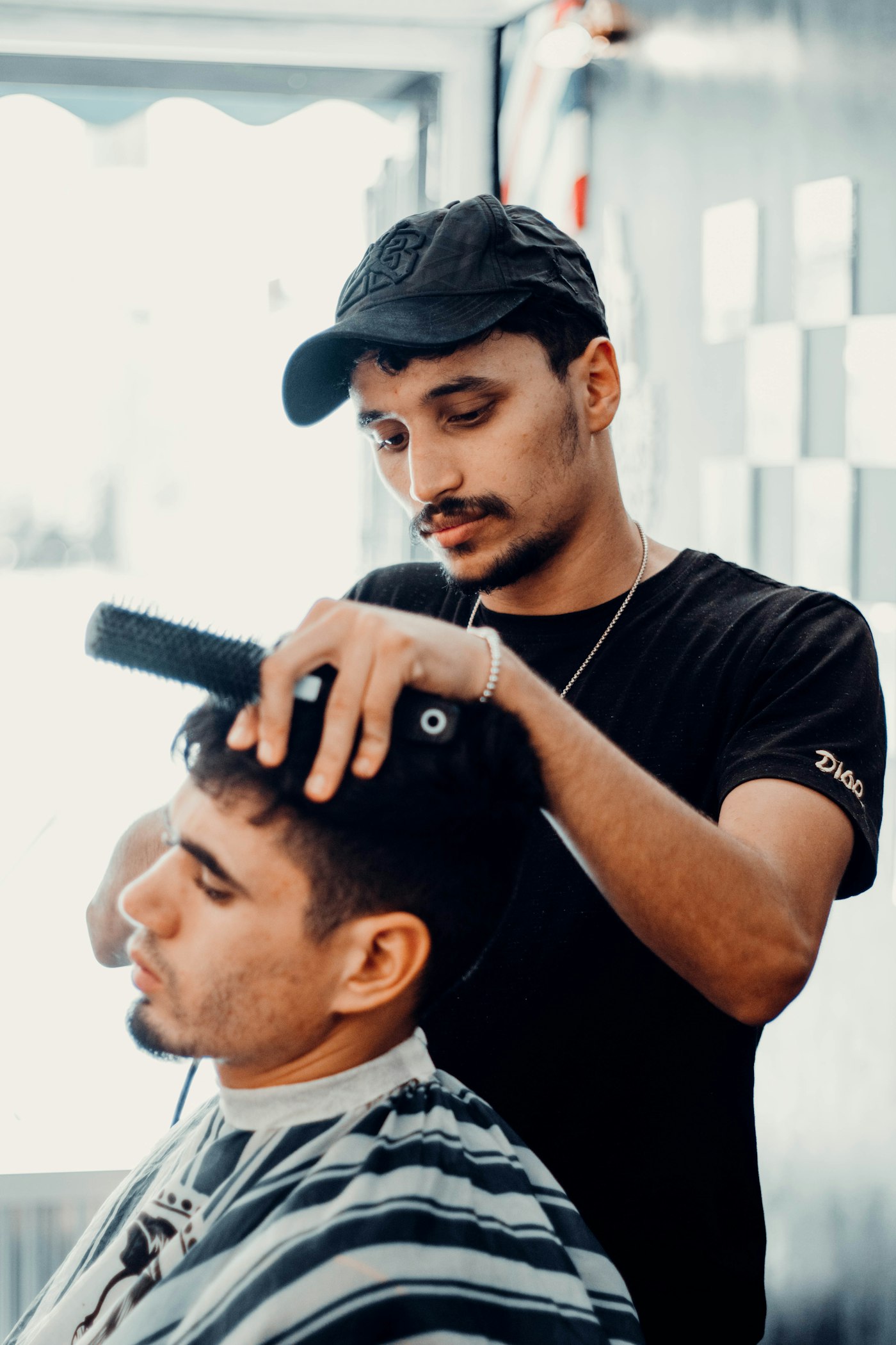 A barber cutting a customer's hair